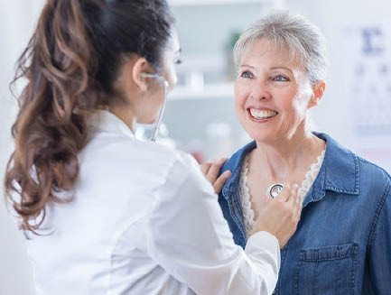 a doctor talks to a smiling patient